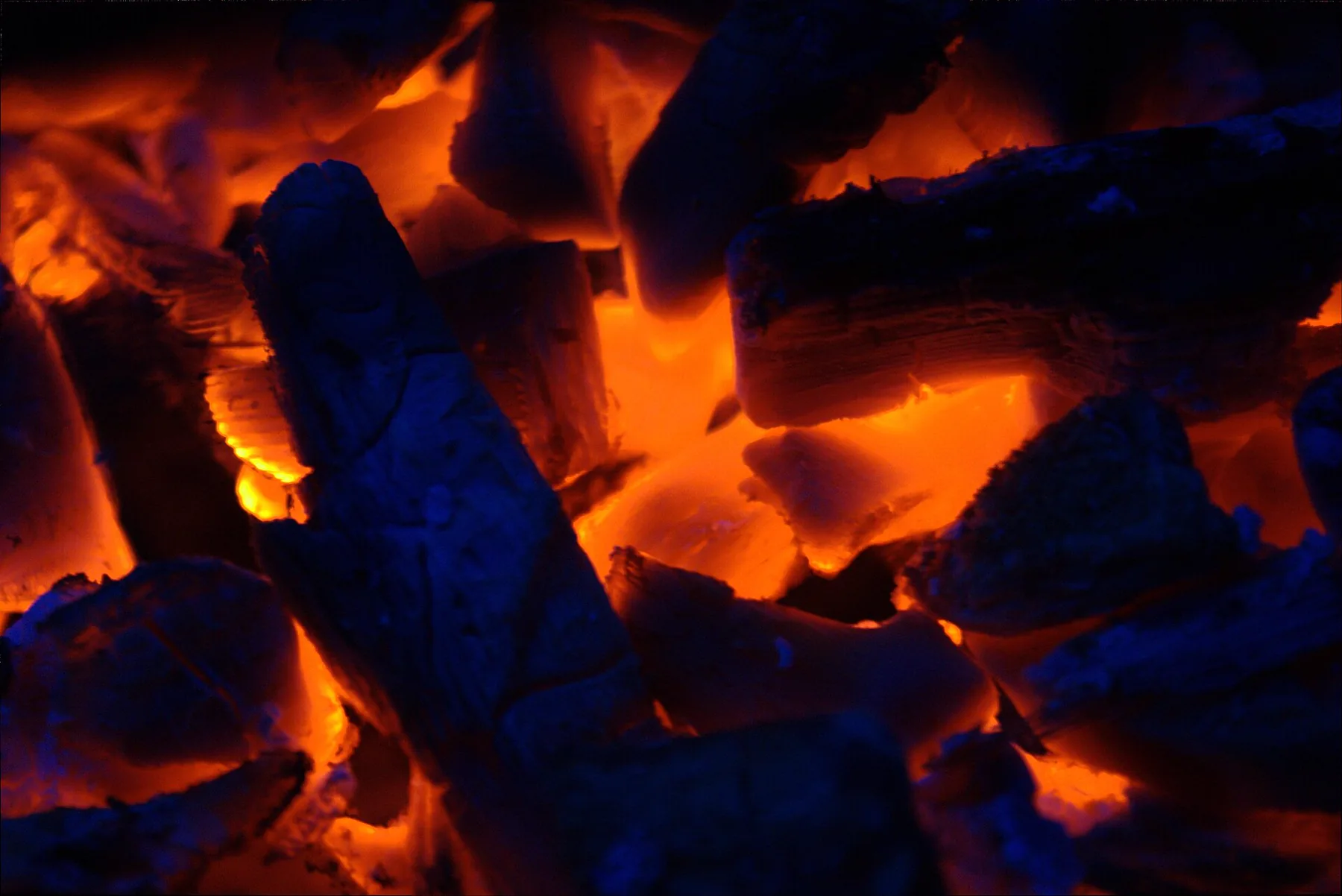 Jagged charcoal silhouetted against a blazing orange glow