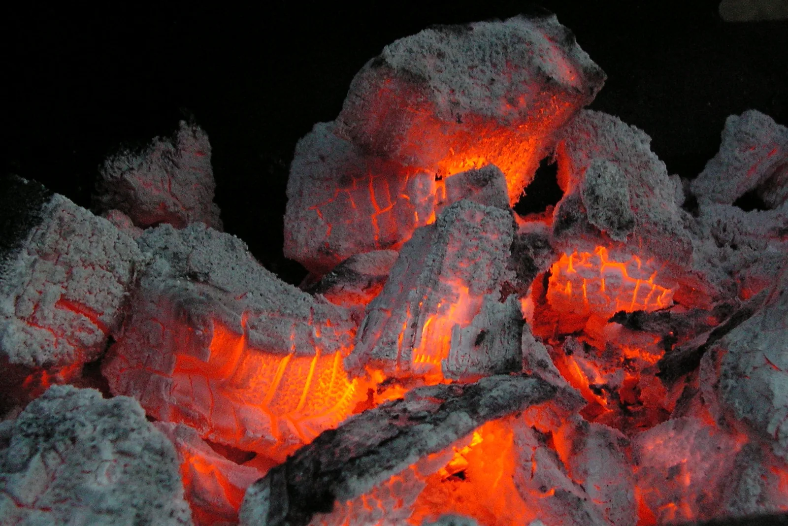 Charcoal with intense orange light glowing up through the cracks